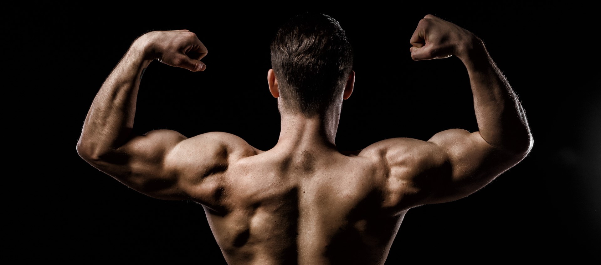 A picture of a man's back as he flexes his muscles