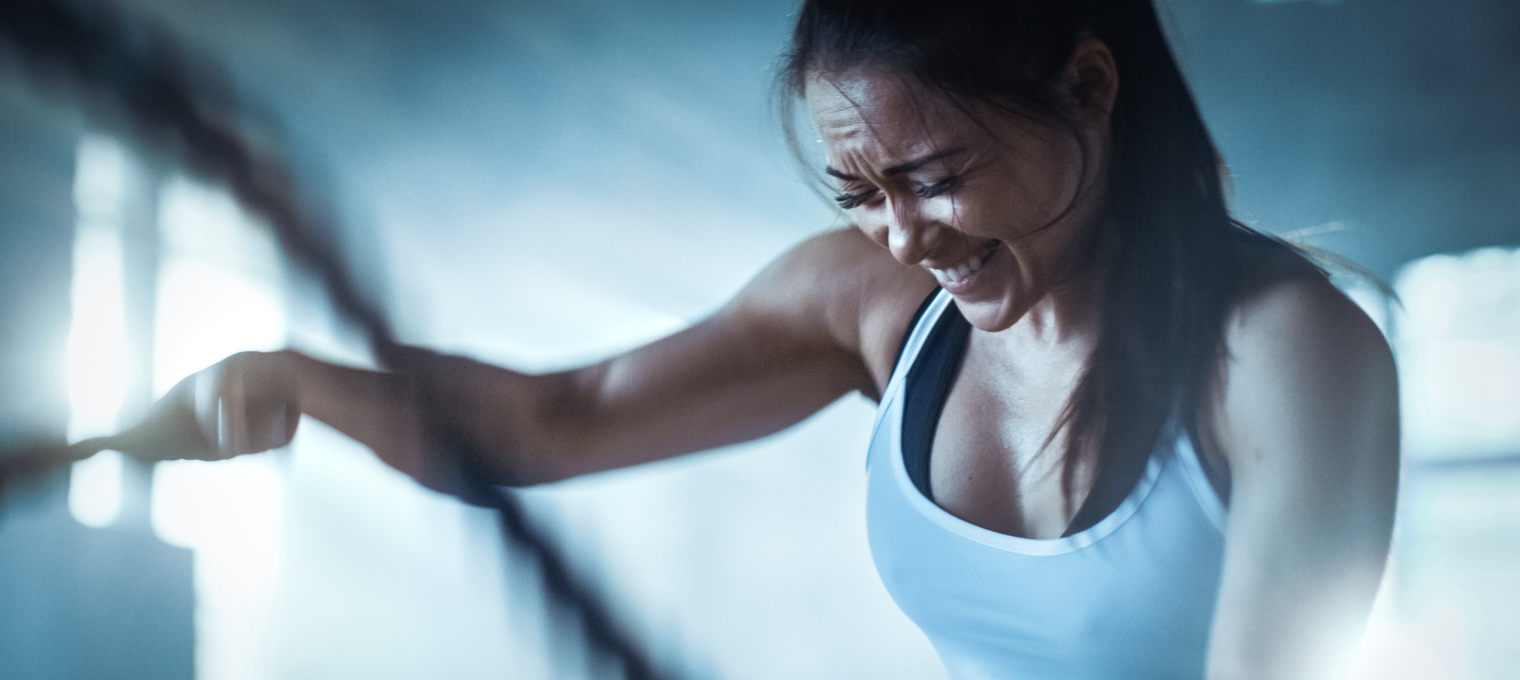 A young woman exercises on a machine