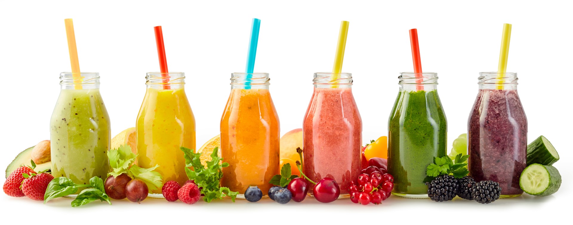Several smoothies of different varieties placed decoratively on a table