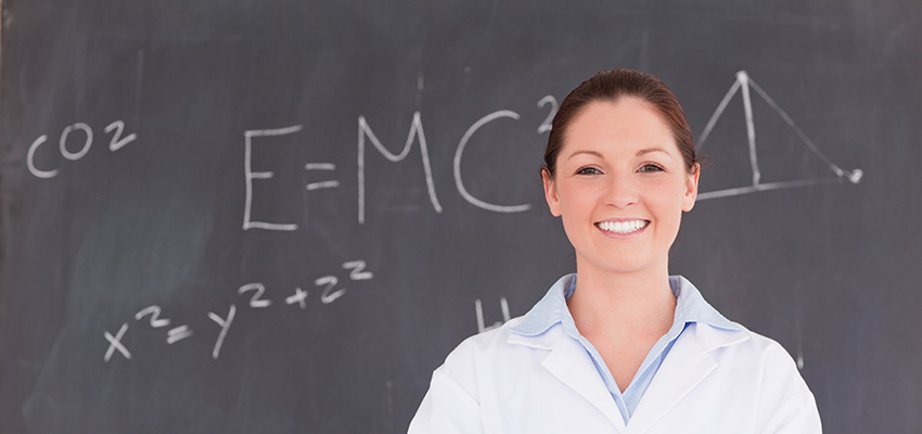 teacher with blackboard full of calculation in the background