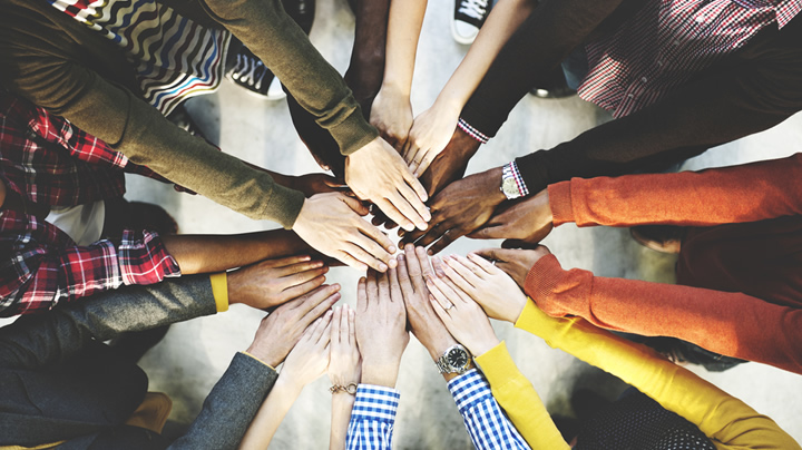 Multi-ethnic group holding hands