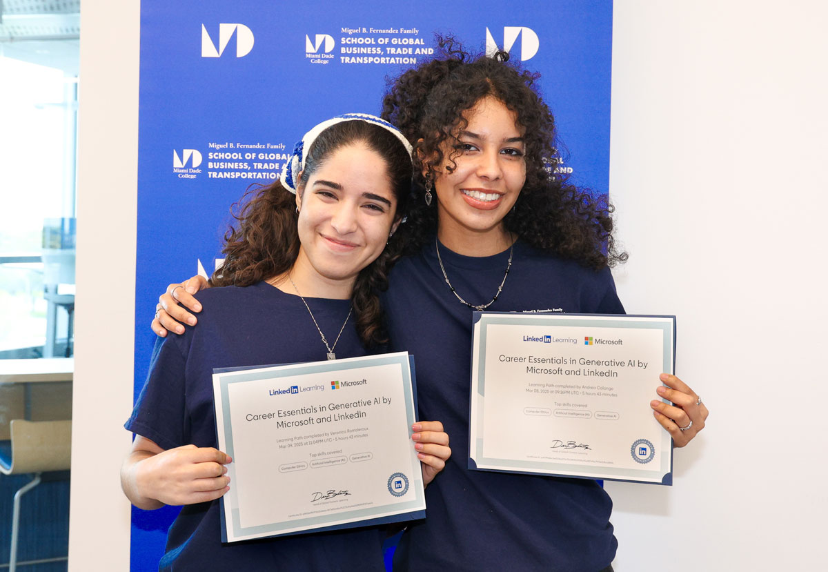 Two students holding a certification