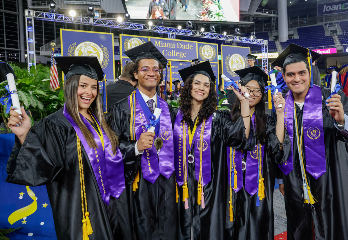 Students holding their diplomas at Commencement