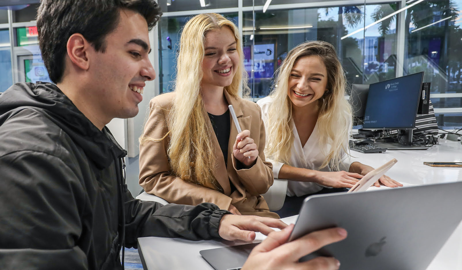 Students collaborating on a laptop.
