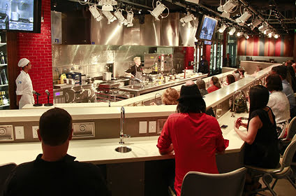 Audience watching a chef demonstration in a teaching kitchen