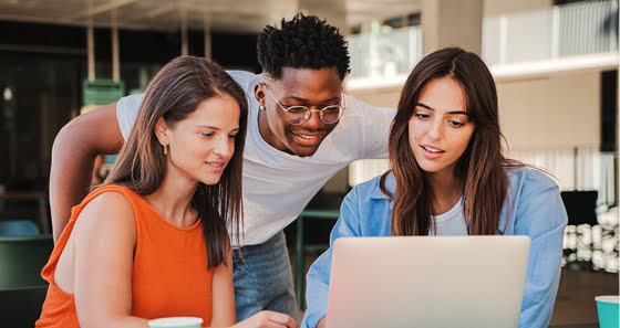 Three students working together at the computer lab