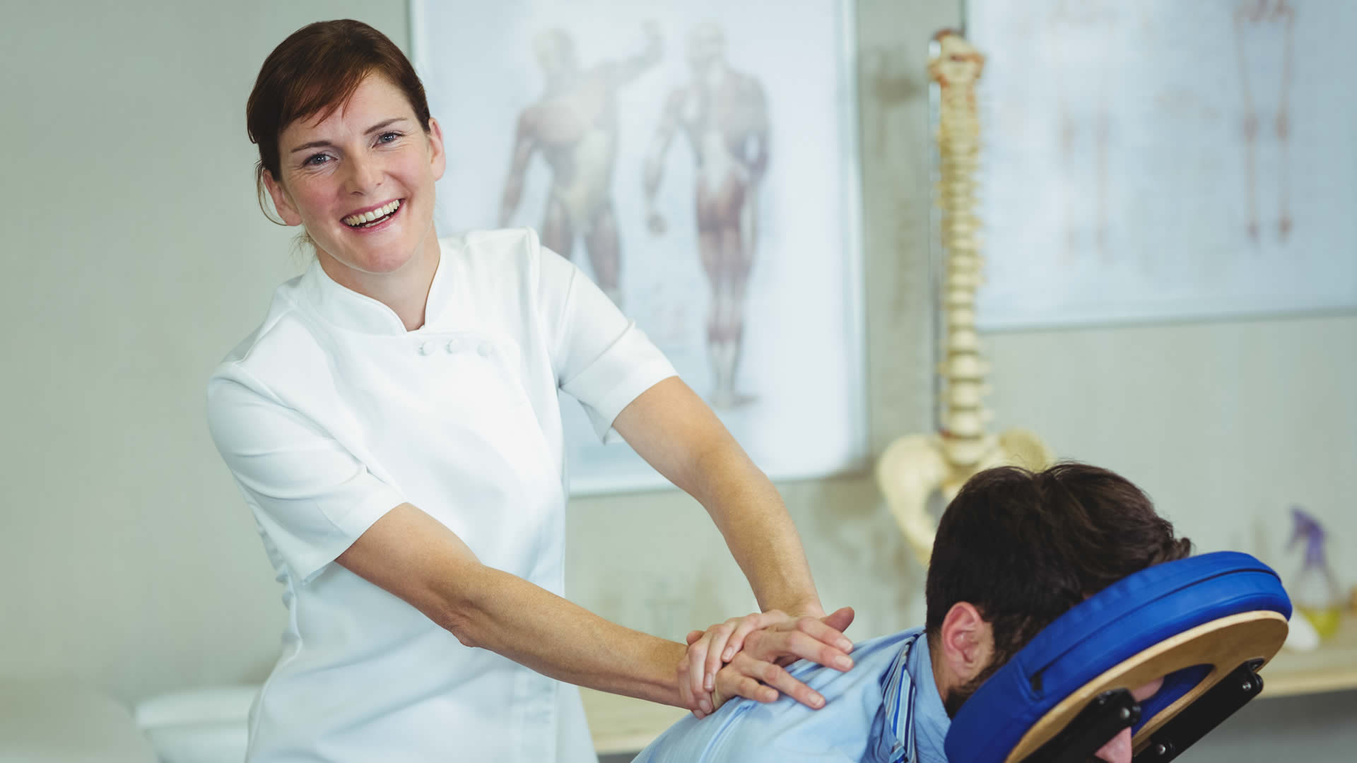 A massage therapy student working with a patient