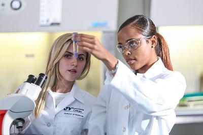 Two MDC students looking at a sample