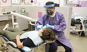 Dental Hygiene student working patient
