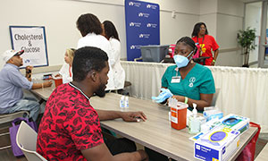 Woman getting sugar measurement at the Community Health Fair