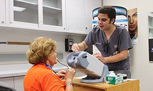 Student checking a patient's vision