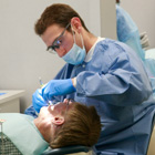 Dental Hygienist treats a patient