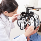 An optometrist tests a patient's vision