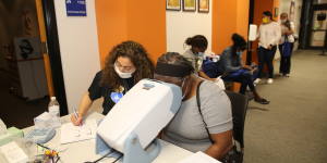 Nurse doing a vision test to a woman at the Community Health Fair