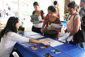 Students gathered around an information table in the Kendall Campsus