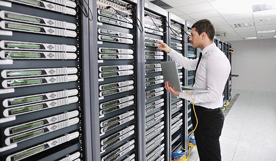 Man working with servers at a data center