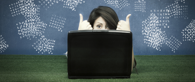 Girl working behind laptop