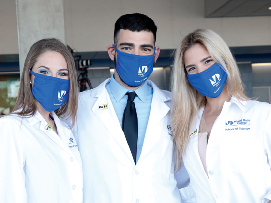 Three medical graduate students posing for camera
