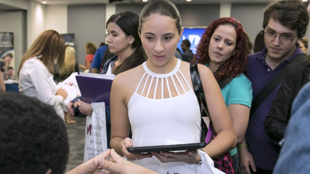 Image of a student in line about to receive assistance from an academic advisor