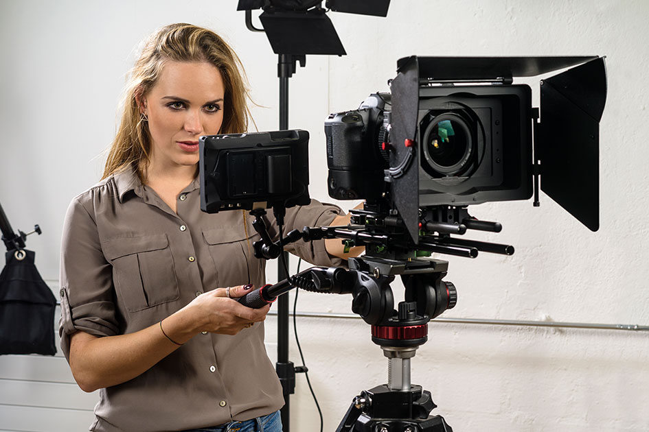 A female student working with video camera equipment
