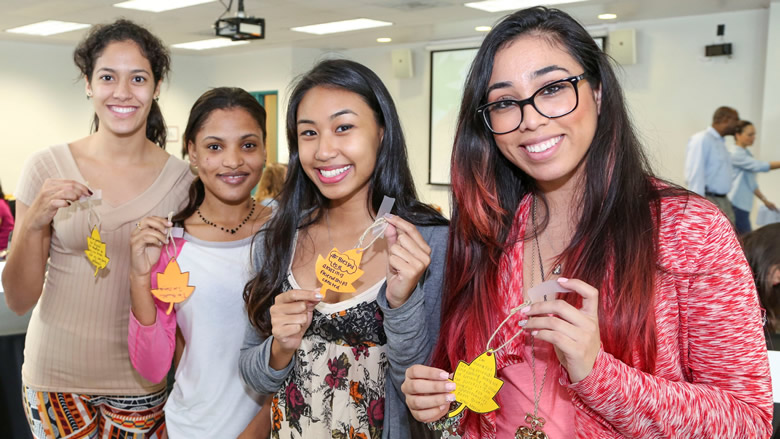 Four female students take a break from studying to pose for a photograph