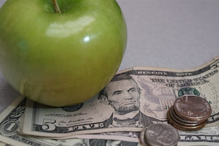 Image of a green apple and money